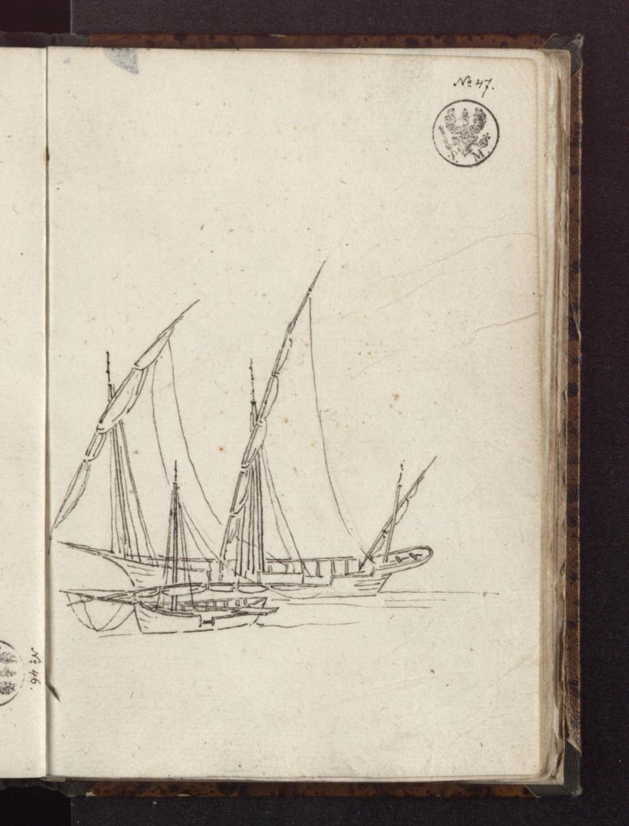 Ein dreimastiger Segler und ein kleineres Boot am Ufer liegend