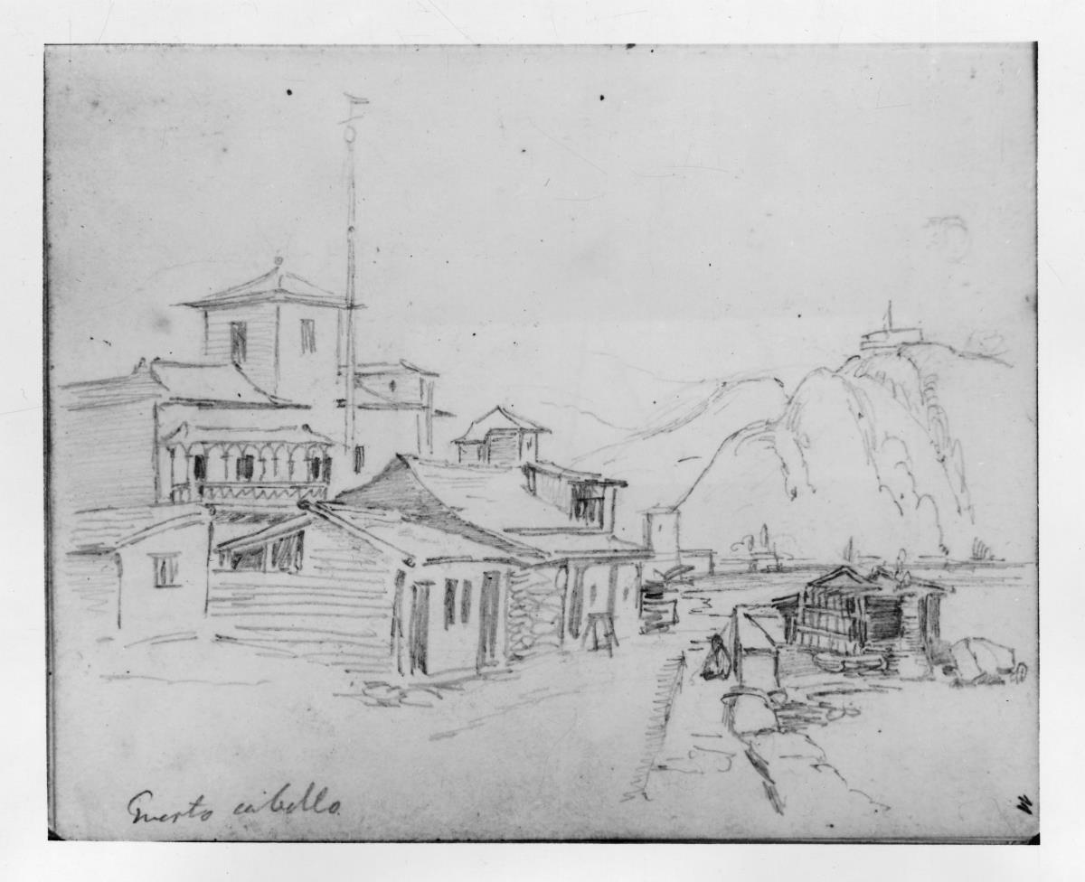Straße mit Holzhäusern in Puerto Cabello, im Hintergrund Berge