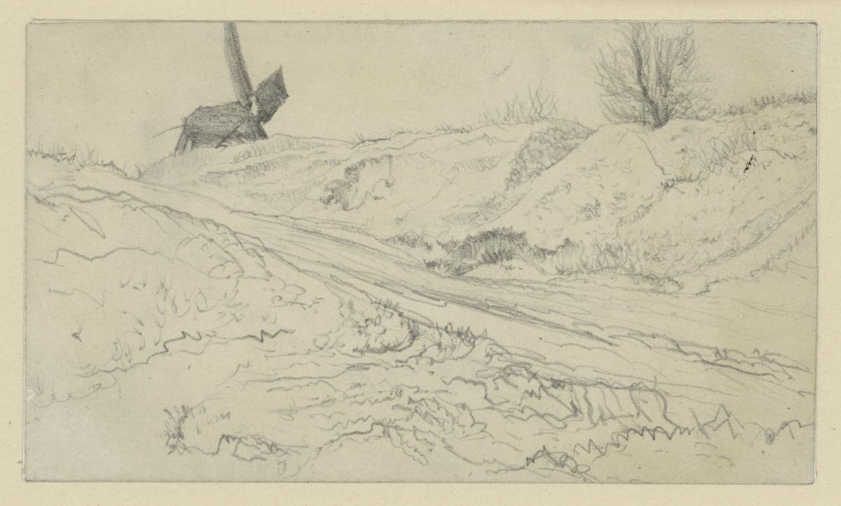 Landweg zur Windmühle zwischen niedrigen Hügeln