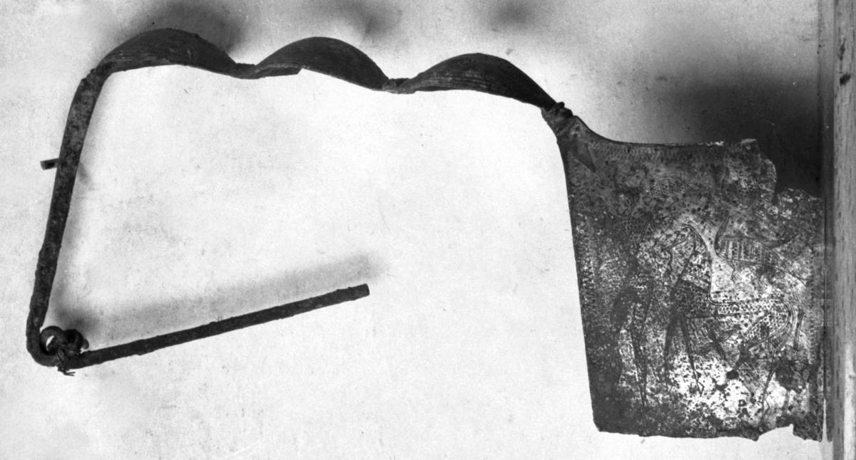 Fibel sog. geometrischen Stils mit großer Platte, auf deren beiden Seiten (Mann mit Pferd; Löwe) angebracht sind