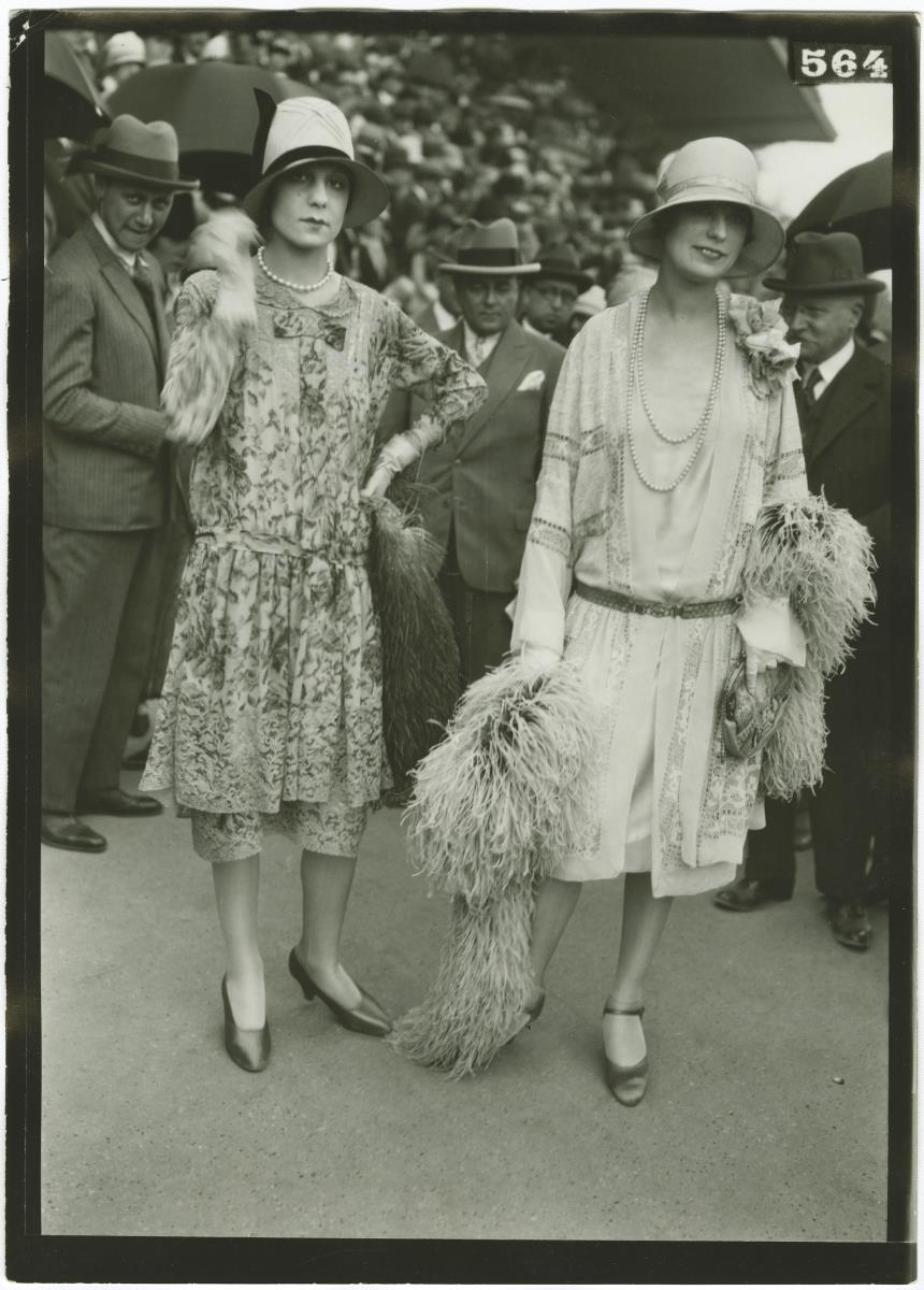 Frau in Kleid und Frau in Ensemble auf dem Rennplatz in Longchamp