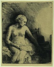 Nackte Frau mit Hut neben sich