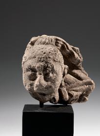 Siddhartha Gautama schneidet zu Zeichen seiner Weltentsagung sein langes Haar mit dem Schwert ab
