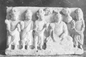 Sitzender Buddha in Schutzgeste (abhaya-mudra) unter blühendem Baum inmitten stehender männlicher Verehrer (Fragment)