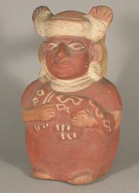 Stehende anthropomorphe Figur mit Feliden im Arm