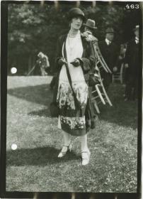 Frau in Kleid und Mantel auf dem Rennplatz in Chantilly