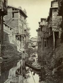 Merchants with a small boat, between their Houses on the  Srinigar Canal