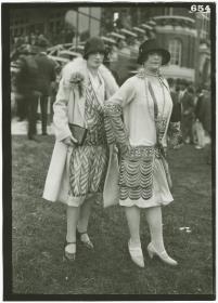 Frau in Kleid und Mantel und Frau in Ensemble auf dem Rennplatz in Deauville