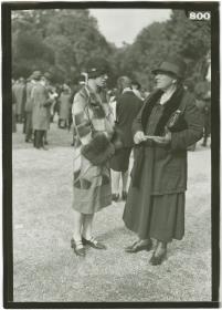 Frau in Mantel und Frau in Ensemble auf dem Rennplatz in Longchamp