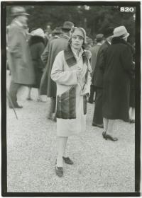 Frau in Mantel auf dem Rennplatz in Longchamp